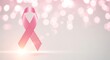 © Ijo - Pink ribbon symbol of breast cancer awareness against blurred background