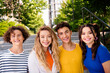 © deagreez - Close friends enjoying time together outdoors in a city setting, smiling and bonding during summer