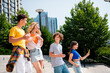 © deagreez - Group of upbeat young friends enjoying a sunny day outdoors in the city celebrating their bond and vitality
