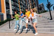 © deagreez - Group of cheerful young friends enjoying outdoor walk in urban city environment on sunny day