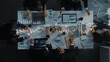 © InfiniteFlow - Aerial perspective of a professional business team engaged in data analysis, discussing insights with digital charts and graphs on a conference table in a modern office setting. Raster