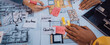 © InfiniteFlow - Professionals collaborate on architectural plans and design ideas, using color swatches and notes in a dynamic brainstorming session to create innovative spaces. SACTR