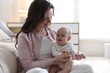 © New Africa - Smiling mother with her cute baby near sofa at home