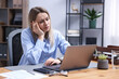 © New Africa - Woman feeling fatigue at wooden desk in office