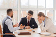 © Pixel-Shot - Male business mediator working with upset clients at table in office