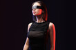 © Pixel-Shot - Young woman in VR glasses on dark background