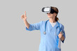 © Pixel-Shot - Female doctor in VR glasses with clipboard using virtual screen on light background