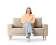 © Pixel-Shot - Young woman sitting on grey sofa against white background