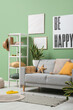© Pixel-Shot - Interior of stylish living room with grey sofa, houseplants and summer decor