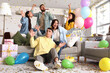 © Pixel-Shot - Group of young friends with whistles celebrating Birthday at party