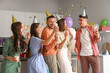 © Pixel-Shot - Group of young friends with drinks and confetti celebrating Birthday at party in kitchen