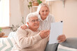 © Pixel-Shot - Senior woman hugging her husband with refund form at home