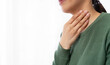 © Ton Photographer4289 - Close-up of woman touching her throat in pain. Representing sore throat, illness, infection, thyroid problem and healthcare concept with copy space.