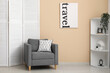© Pixel-Shot - Folding screen, shelving unit and armchair near beige wall in room, closeup