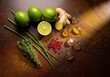© PhotoHub - Fresh lemons, ginger, herbs, and spices on a rustic wooden surface with a warm lighting effect