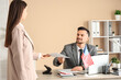 © Pixel-Shot - Handsome young man and female colleague with flag of USA working in office