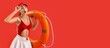 © Pixel-Shot - Surprised female beach rescuer with lifebuoy on red background with space for text