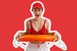 © Pixel-Shot - Surprised female beach rescuer with lifebuoy on red background