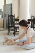 © Jirawatfoto - Calm peaceful asian woman sitting comfortable on floor cushion at home improving daily mental health and lifestyle wellness by gently touching friendly cat pet feeling relaxed happy