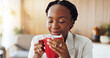 © peopleimages.com - Happy, black woman and coffee with smell for caffeine aroma, start day or essence in home. Female person, relax and calm with smile, mug or cup for warm drink, beverage scent or energy in house