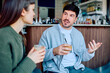 © we.bond.creations - Two friends engaging in a lively discussion at a coffee shop, enjoying beverages in a relaxed social setting