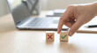 © Choat - Hand choosing wooden block with green check mark over red cross, concept of decision making, right choice and business evaluation.
