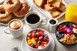 © Malika - Delicious hotel breakfast setup with bagels, smoothie bowls, and drinks