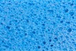 © Mint Images - Close up full frame of a blue cleaning sponge with a pitted porous surface, a plastic household object.