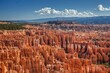 © Mint Images - An intricate maze of towering hoodoos glows in vivid red and orange under a bright blue sky at Bryce Canyon National Park, showcasing the parks dramatic and unique geological formations.