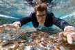 © YouraPechkin - Man in suit swimming underwater among coins in a pool during daylight