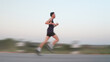 © pixfly - Athletic runnersMotion blur side view of young man running fast on asphalt road outdoor during sunset for healthy lifestyle concept in motion blur, representing speed and active lifestyle