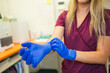 © Gonzalo Infiesta - Veterinarian technician putting on blue surgical gloves