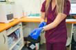 © Gonzalo Infiesta - Medical professional wearing blue gloves in clinic
