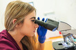 © Gonzalo Infiesta - Female veterinarian seeing through microscope researching animal health