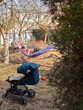 © phpetrunina14 - Father relaxing in hammock in backyard with stroller