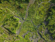 © AmazingAerialAgency - Aerial view of lush green fields and pathways intertwine, creating a vibrant tapestry of nature's beauty, Klaten Regency, Jawa Tengah, Indonesia.