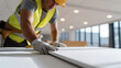 © photo for everything - Skilled Construction Worker in Safety Gear Precisely Install Drywall Panel for Modern Interior Build, Focus on Hand and Material