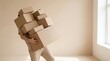 © Stock Palace - A person carries a very large and heavy stack of cardboard boxes appearing to struggle with the excessive load during a move