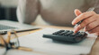 © sebra - Close-up view woman's hand using a calculator