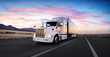 © dell - White semi truck / lorry and highway / road at sunset - transportation background. Beautiful sky and romatic feel. White body / side of the truck. Wide angle / panoramic view.