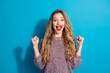 © deagreez - Young stylish woman with bright smile celebrating success against blue background