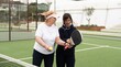 © Angelov - a girl teaches her grandmother how to play padel