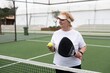 © Angelov - mature woman playing padel on outdoor court.