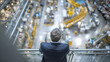 © Creative Valley - Business executive overlooking automated manufacturing facility, industrial leadership concept featuring factory production, modern engineering operations, innovation, strategy and industry management