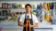 © freechoice - Young man wearing apron and holding a bolt cutter in a hardware store
