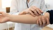 © Iuliia - Woman doctor using stethoscope to listen to patient arm. Medical examination and checkup concept. Healthcare diagnosis.