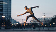 © jambulart - A person performing a dance leap outdoors at dusk.