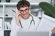 © InsideCreativeHouse - Friendly male general practitioner doctor wearing eyeglasses , giving medical consultation online to patient, using video web camera call computer laptop application in clinic office.