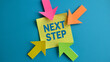 © hunzra - Colorful sticky note with next step message and arrows