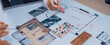 © InfiniteFlow - Engaging scene of hands collaborating on an architectural floor plan. Colorful swatches and detailed layout sketches showcase creative design processes in a modern workspace. SACTR